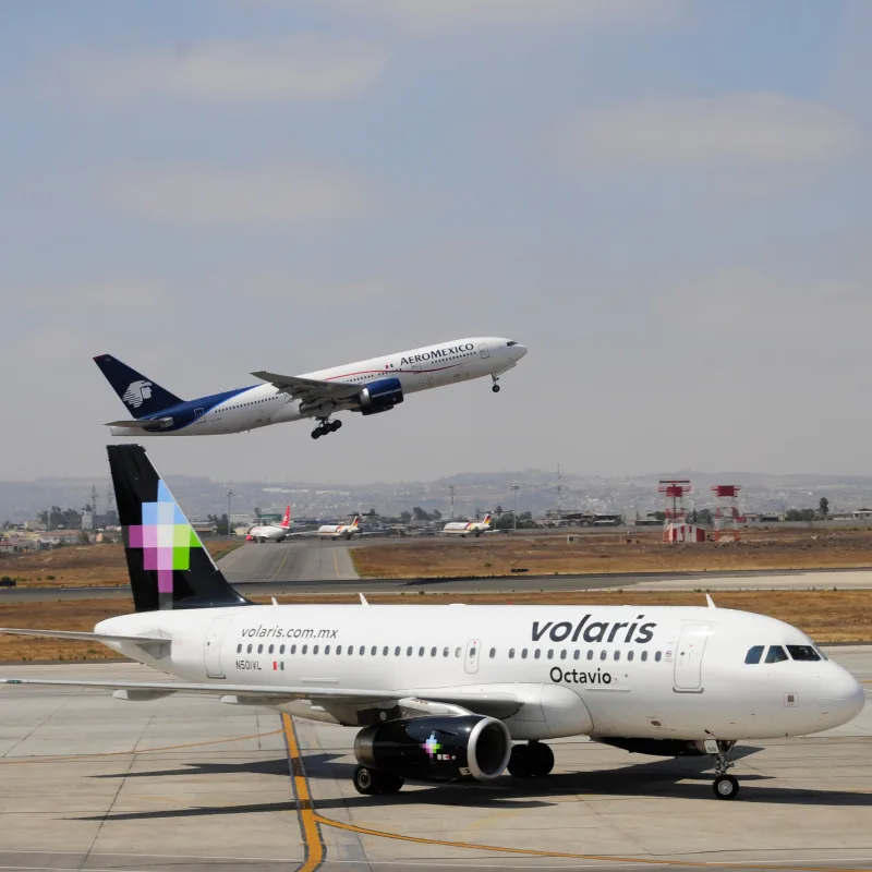 Volaris and Aeromexico airplanes at an airport