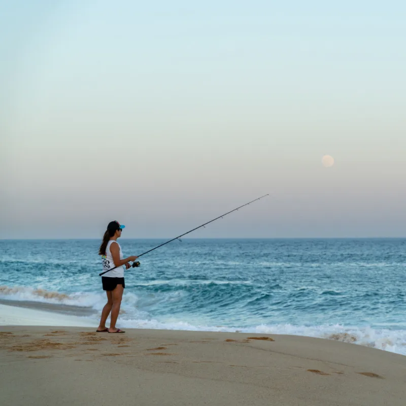 woman fishing on the beach los cabos