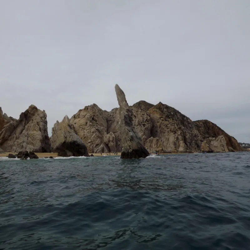Boat cruising at Cabo san Lucas with pinnacle rock in back ground