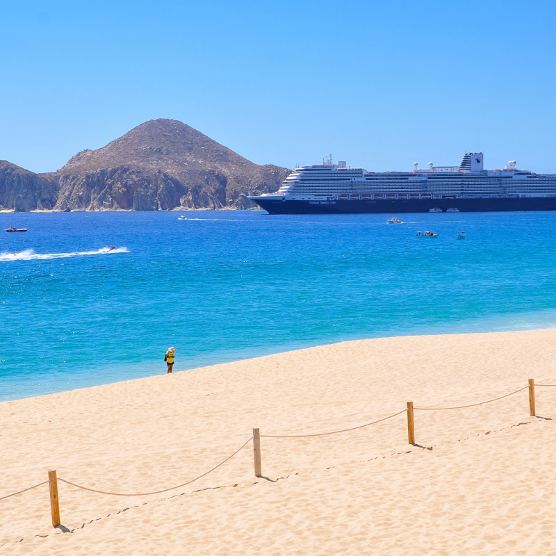 Cabo San Lucas, Mexico - February 23, 2022 Holland America Line cruise ship in the horizon as seen from Playa Medano in Los Cabos in a beautiful sunny day