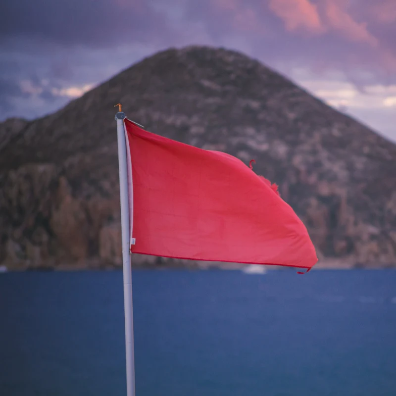 red flag on high tide beach