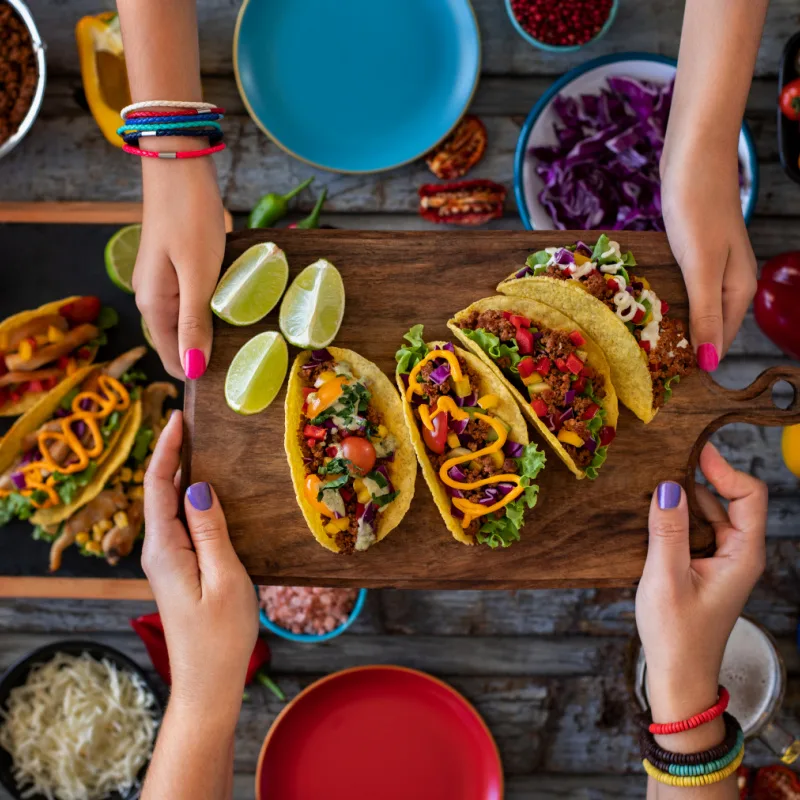 A selection of tacos on a wooden board