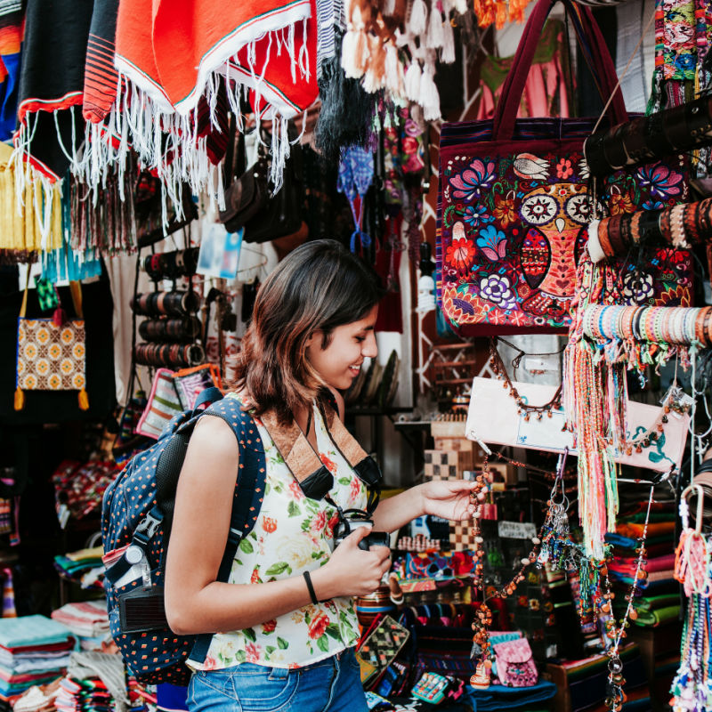 woman looking at items in outdoor market