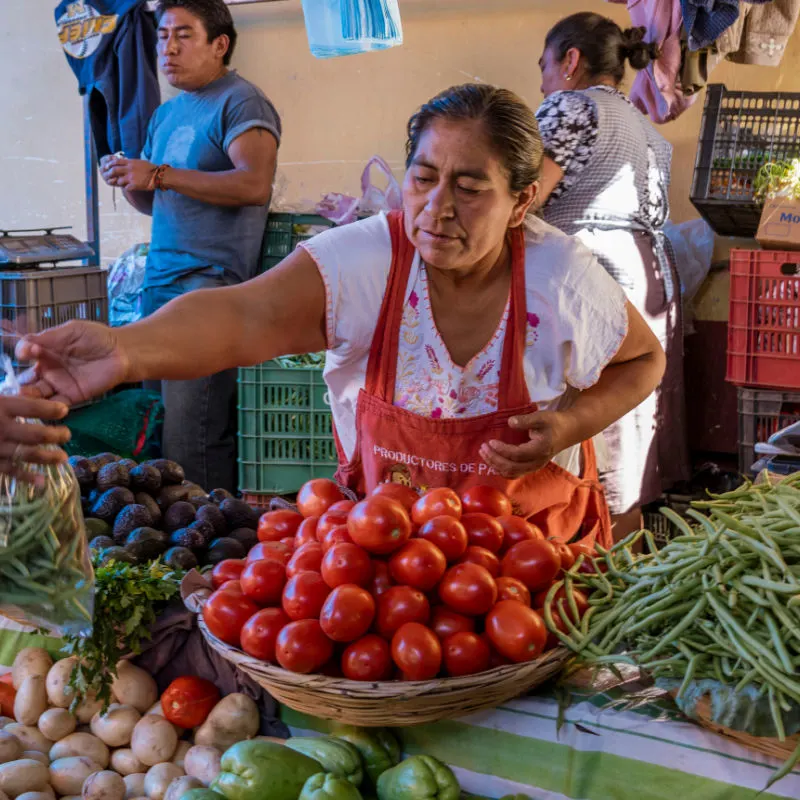 woman selling food in outdoor market