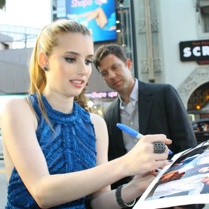 Actress Emma Roberts signing an autograph at the premiere of the movie Scream 4 at Grauman's Chinese Theatre