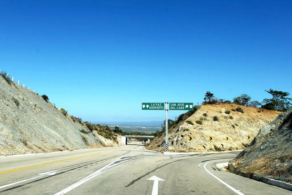 Highway in los cabos with sign for the airport