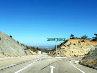 Highway in los cabos with sign for the airport