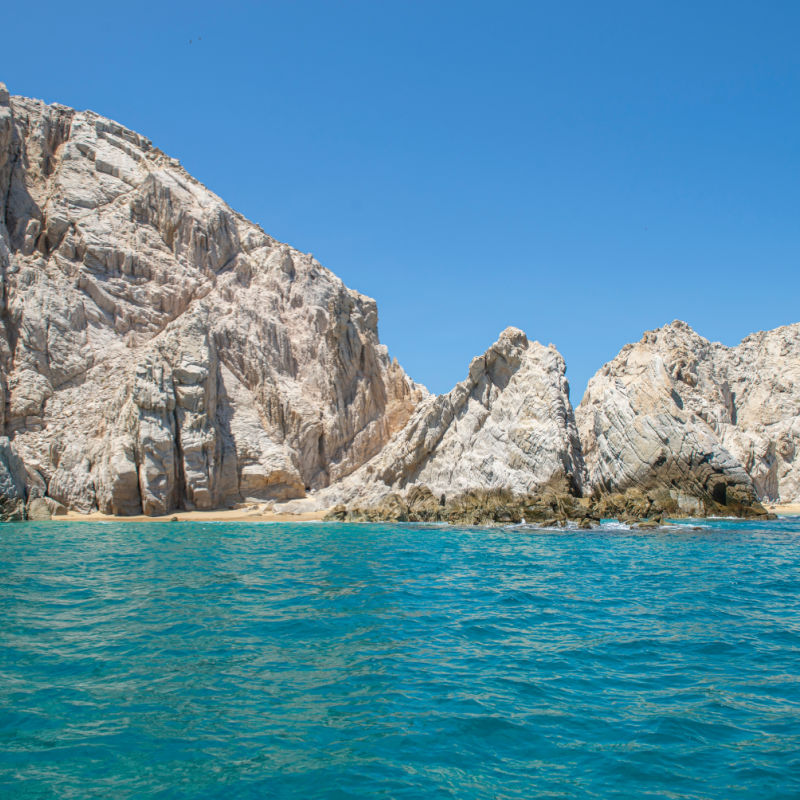 Rock formation near The Lovers Beach in Baja in Los Cabos, with the blue ocean and under a sunny summer day, Cabo San Lucas Baja California Sur.