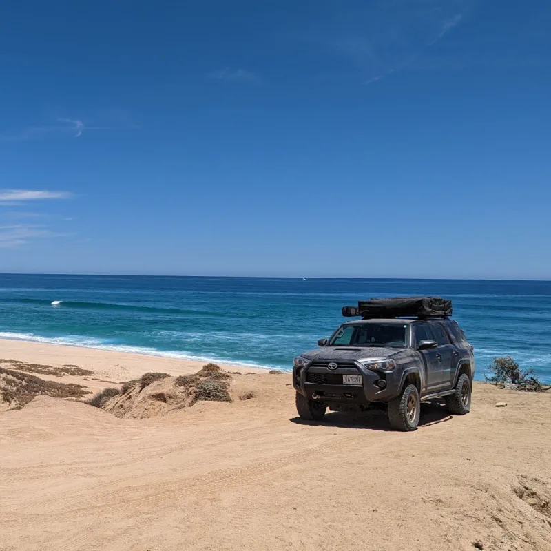 suv parked on beach in cabo