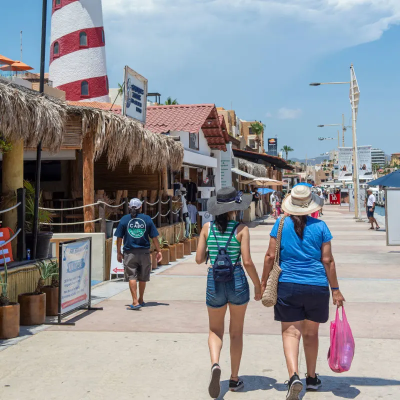 tourists walking on a street in los cabos