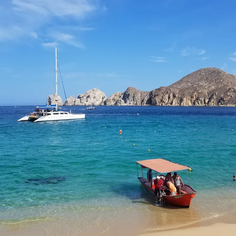 Boats in a beach in Los Cabos on a sunny day