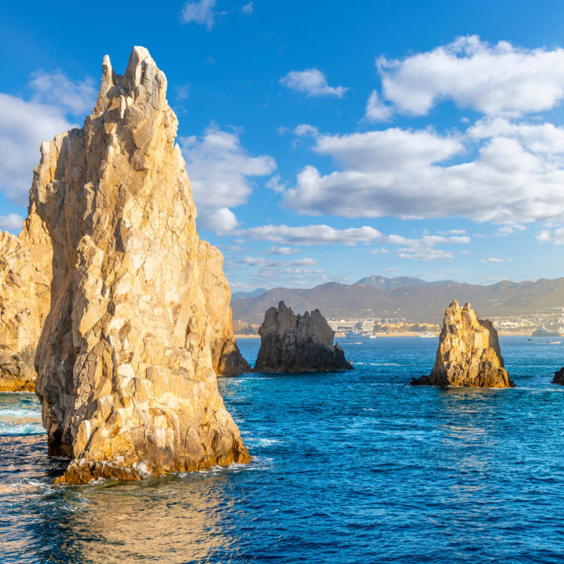 Late afternoon sun highlights the Friars rock formation at Land's End, on the Baja Peninsula at Cabo San Lucas, Mexico