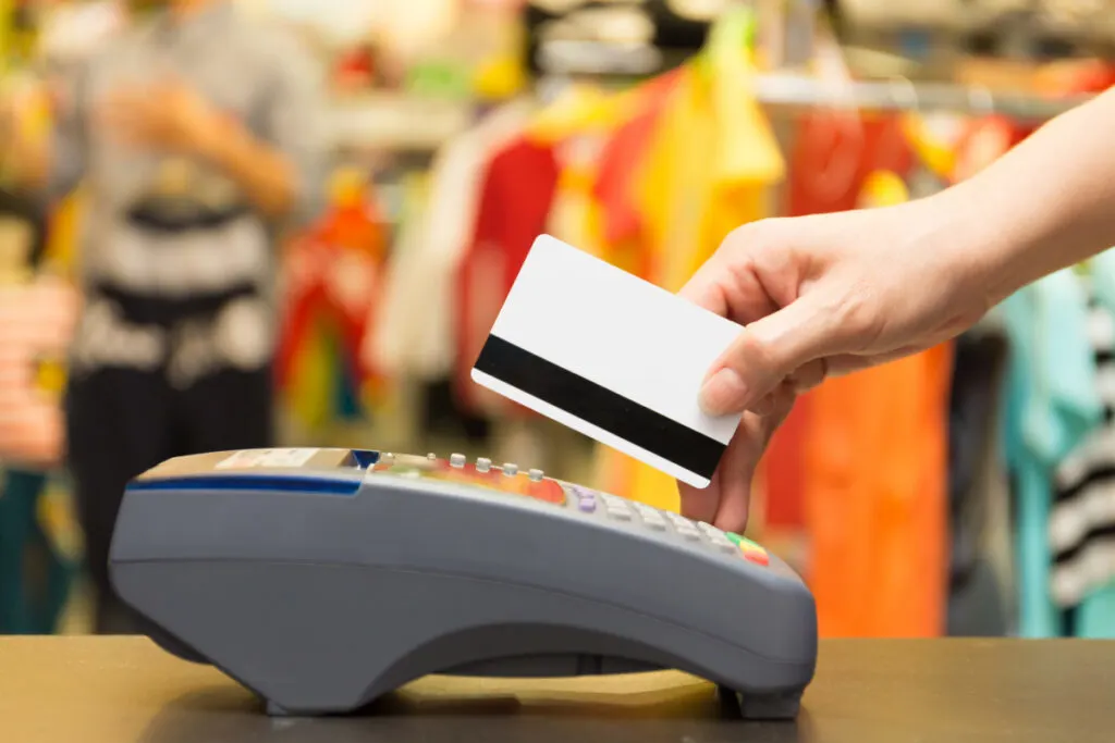 Person Swiping a Credit Card at a Terminal in a Store