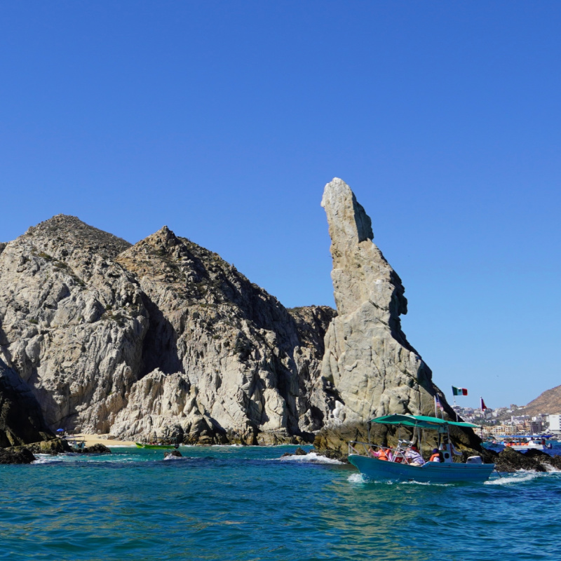 Rock Formations at Lands End, Cabo San Lucas Mexico. Boat of tourists in the front