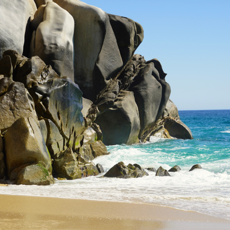 Stunning rock formation with sea and beach on a sunny day in Los Cabos