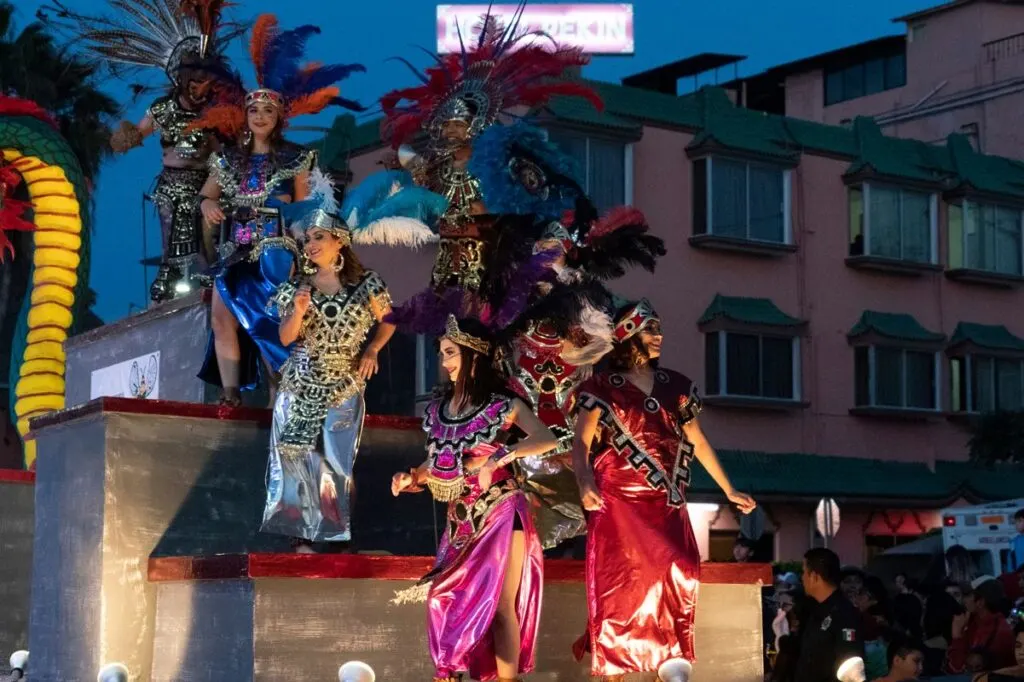 La paz carnival float with colorful performers on board