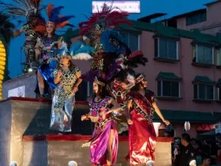 La paz carnival float with colorful performers on board