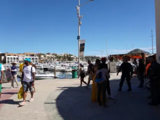 Tourists and Guards in the Marina Area of Cabo San Lucas, Mexico