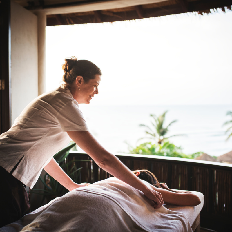 a lady receiving a massage at a wellness retreat