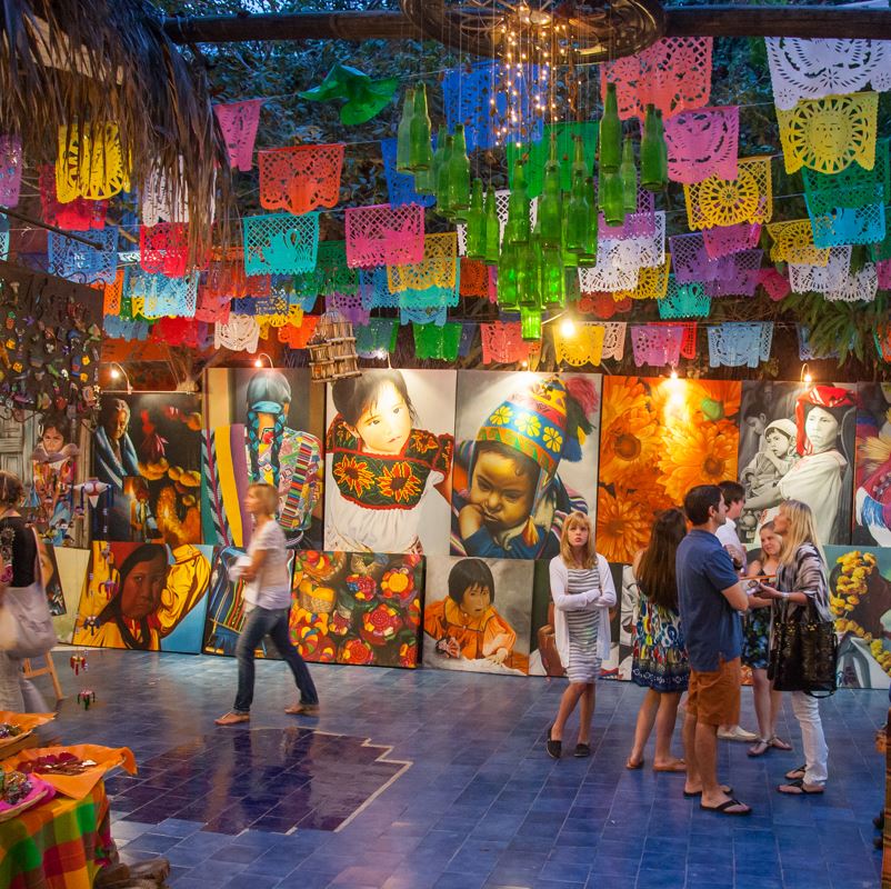 An art filled alley in Los Cabos with colorful decoration hanging from the ceiling