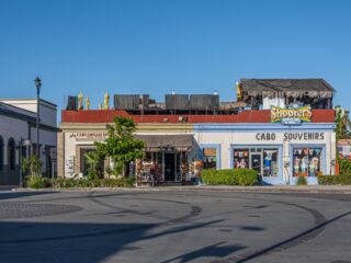 San Jose del Cabo Centro, Mexico: Retail facades on Blvd. Antonio Mijares near central plaza under blue sky.
