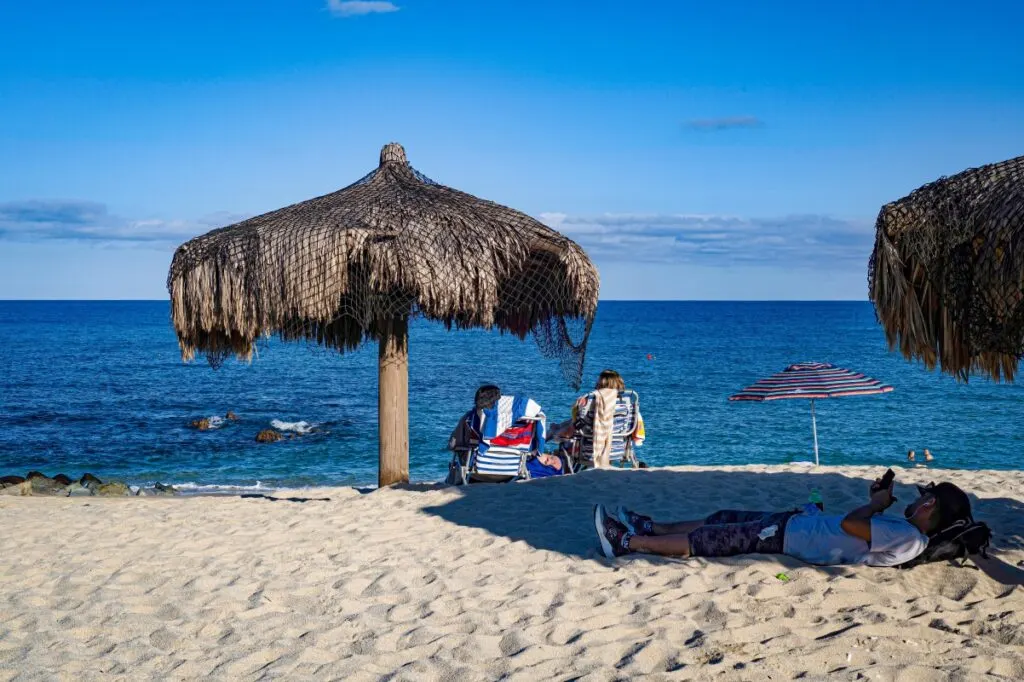 Photo of people lying and sitting on Palmilla Beach in Los Cabos