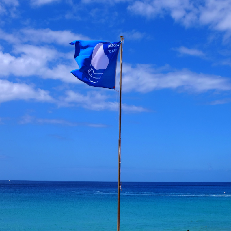 blue flag on gorgeous beach