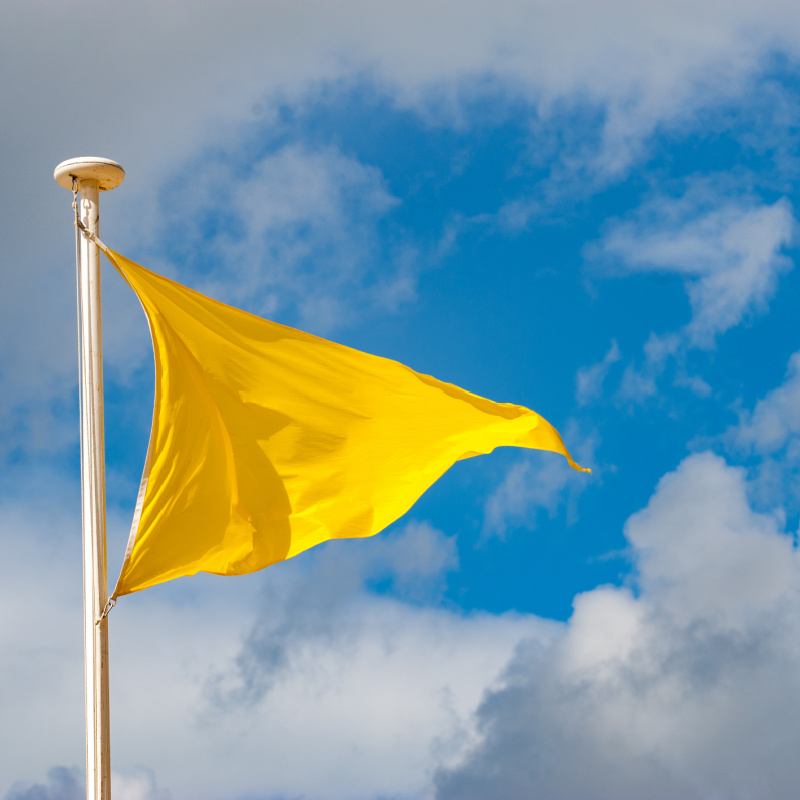 yellow flag flying in the air