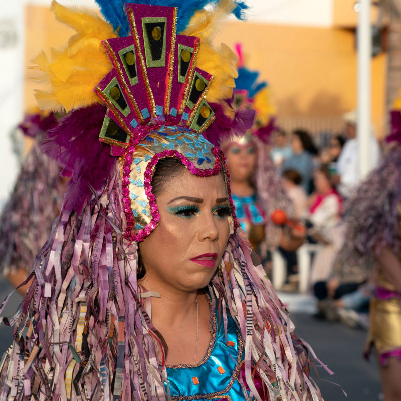 Close up of a woman face in a colorful costume parading at the La Paz Carnival