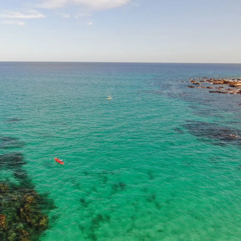 Aerial of stand up paddle boards in clear blue marine waters in Jose Del Cabo, Mexico