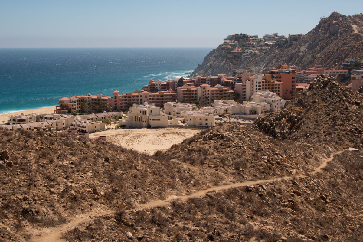 Wide view of coastline with ocean, beach, and city in Cabo San Lucas, Mexico
