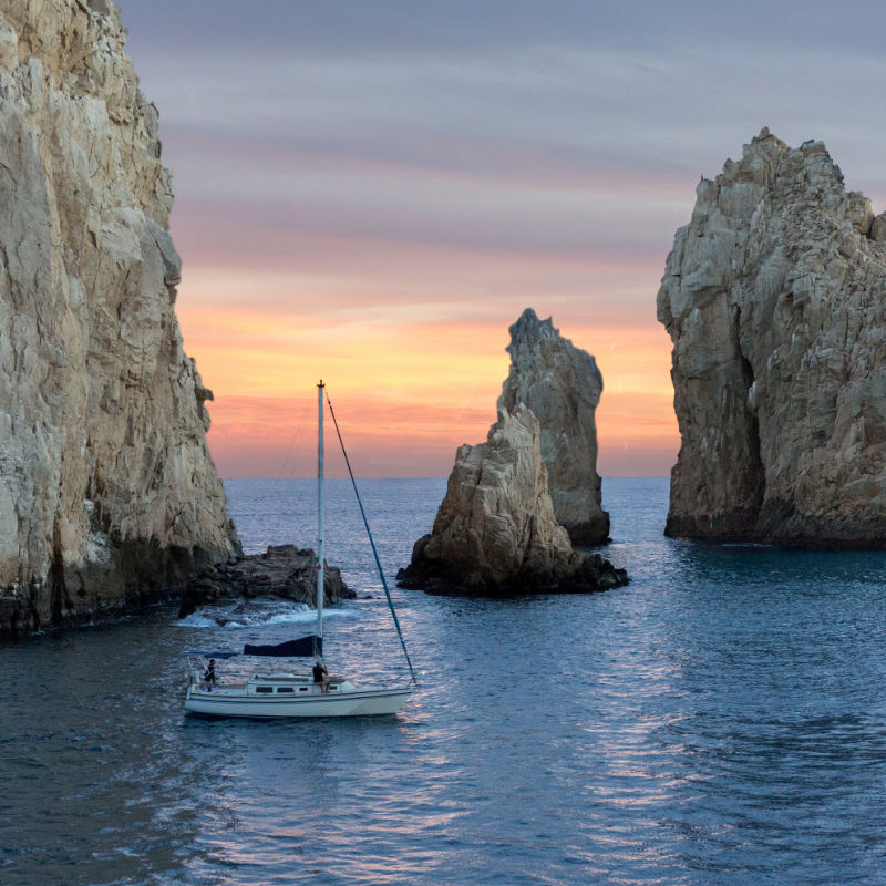 Sailboat on a Sunset Cruise Near Land's End in Cabo San Lucas, Mexico