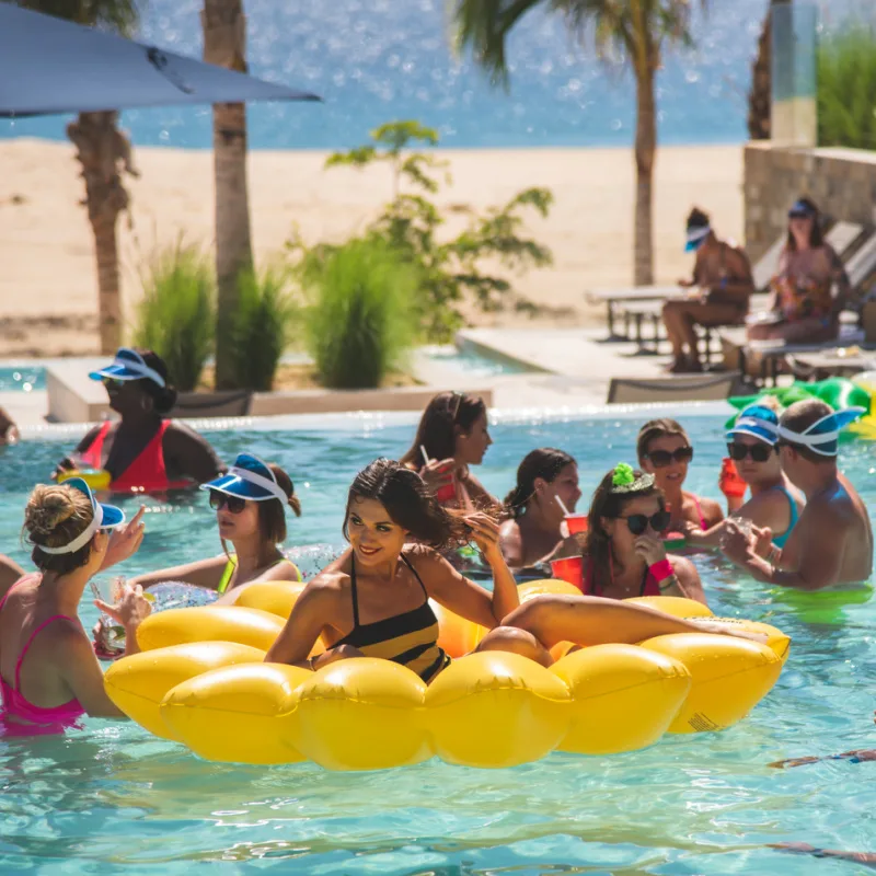 tourists in cabo resort pool on spring break