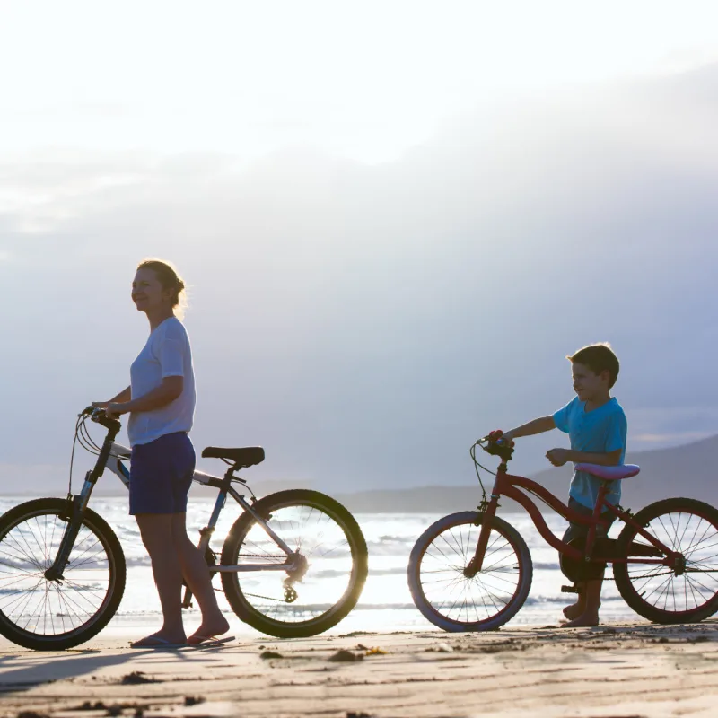 Mother and Son on Bikes on the Beach