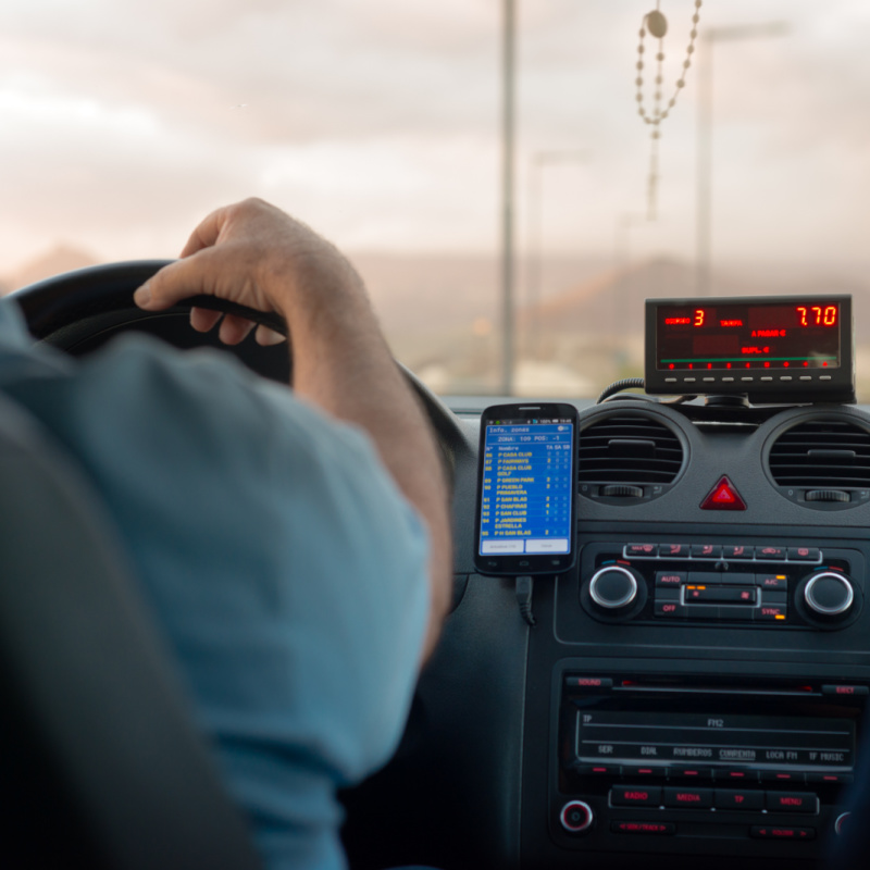 Driver in a Taxi with the Fare Displayed on a Meter