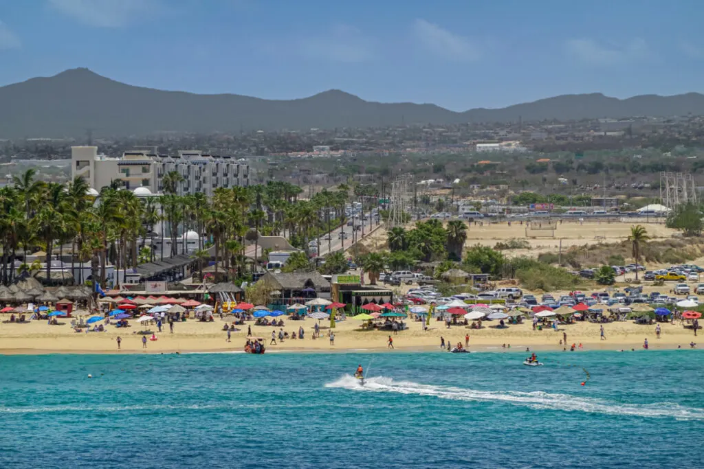 Tourists and Beach Umbrellas on a Beach in Cabo San Lucas, Mexico