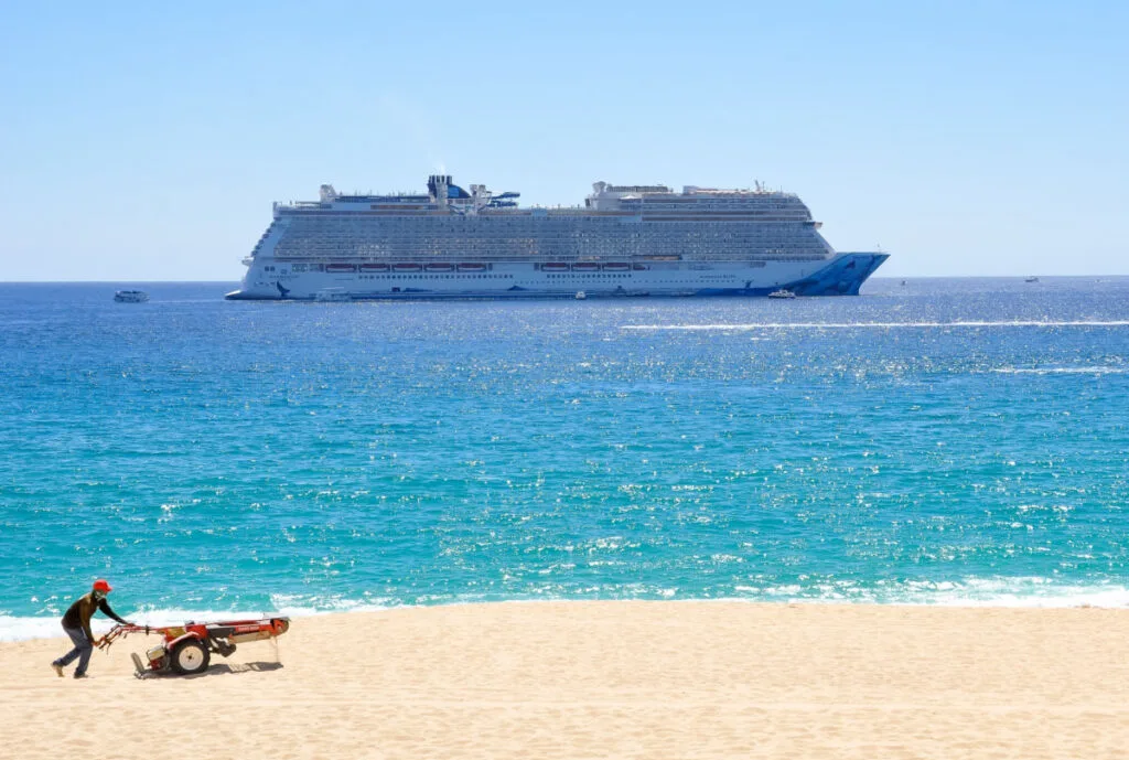 Cabo San Lucas, Mexico - February 23, 2022 Norwegian Bliss cruise ship in the horizon as seen from Playa Medano in Los Cabos.