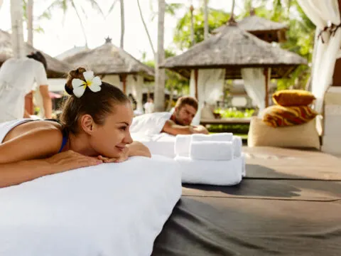 Couple enjoying outdoor massages at a wellness location at a resort