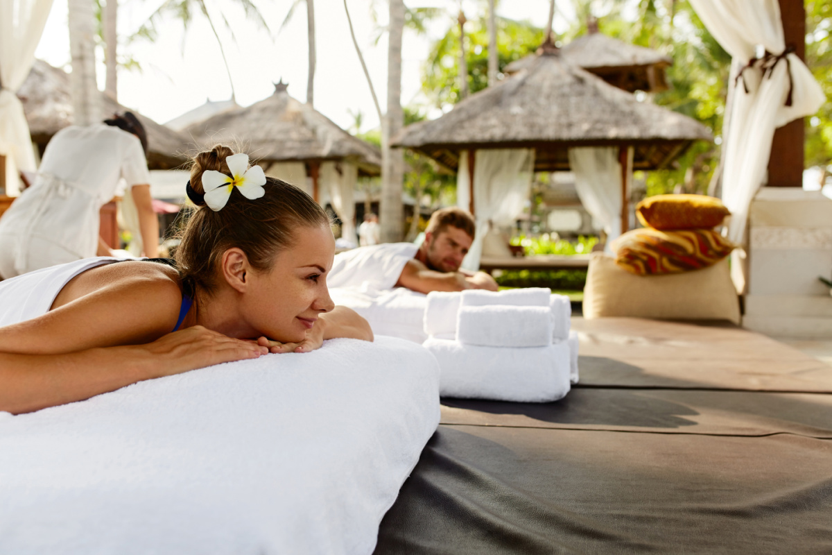 Couple enjoying outdoor massages at a wellness location at a resort