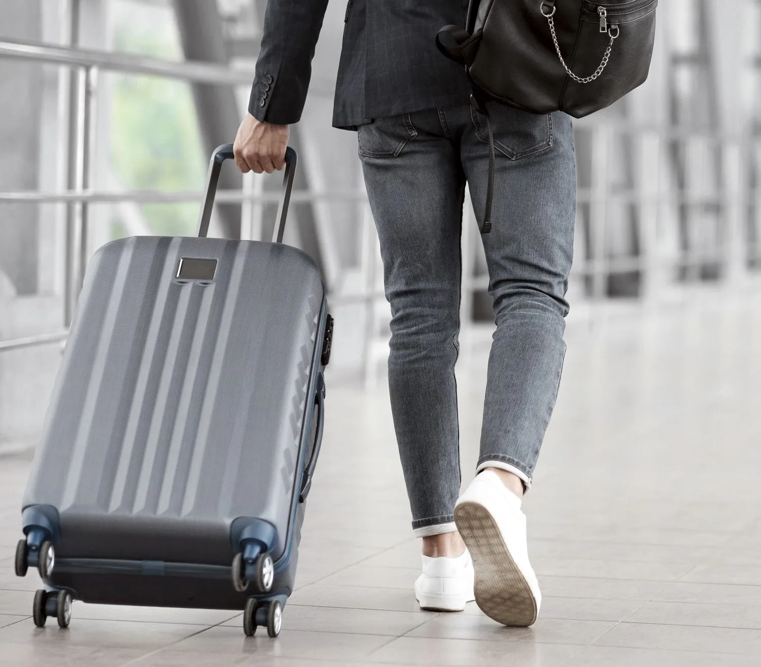 Travelers pulling luggage in airport