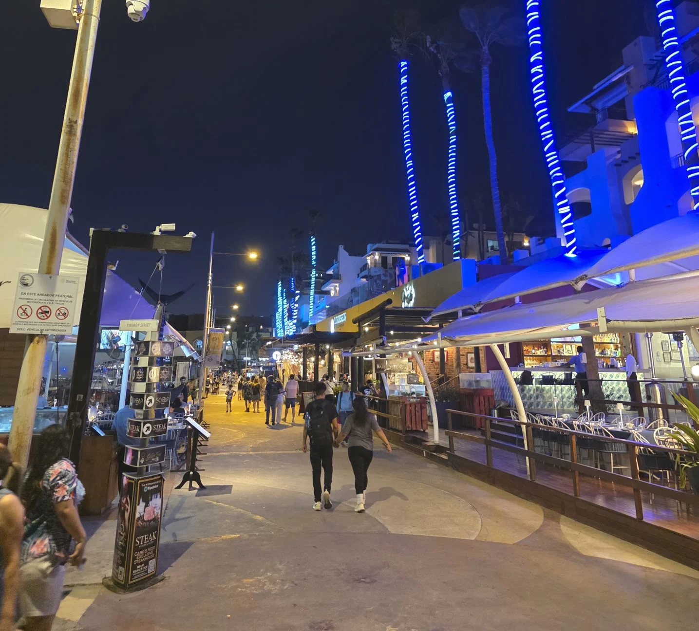 Exploring Cabo Marina at nigth couple walking