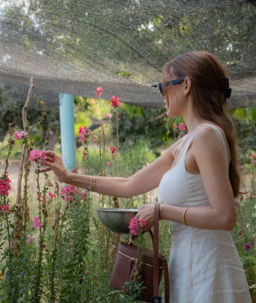 Miraflores Mar del Cabo woman picking something in garden