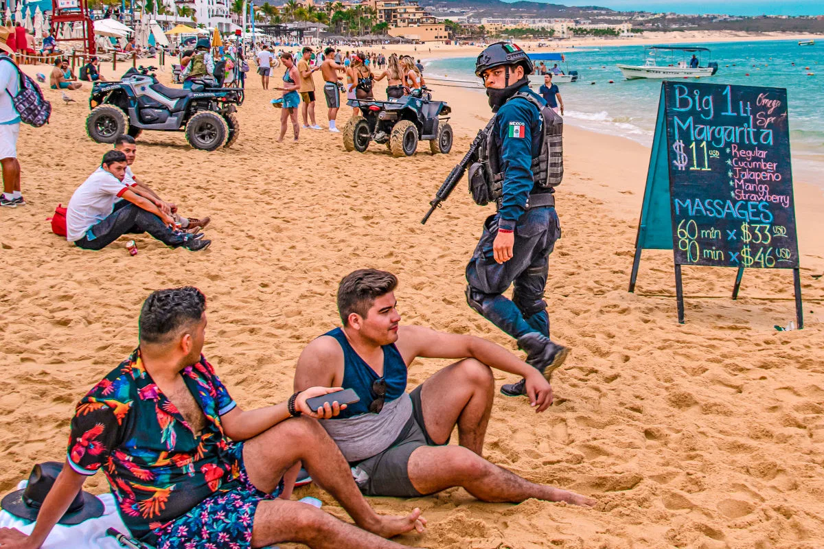 Soldier walking along beach in los cabos. Troops