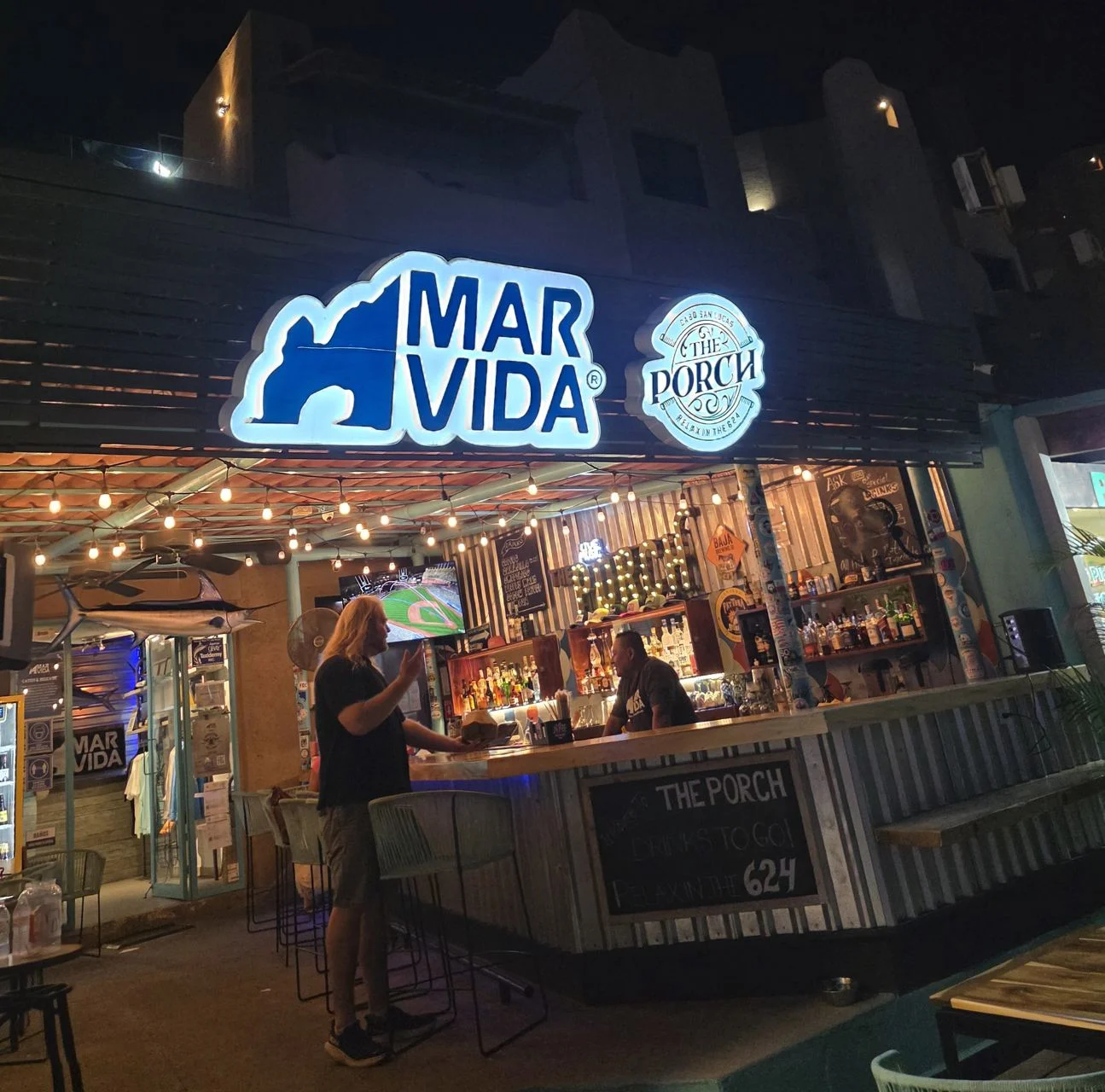 Tourist talking to bartender at restaurant in Marina