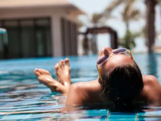 Woman in luxury villa pool