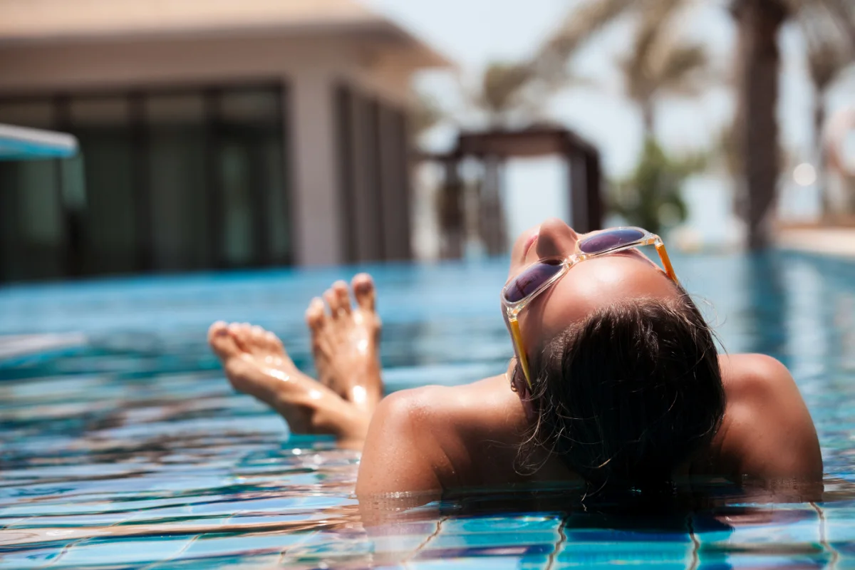 Woman in luxury villa pool