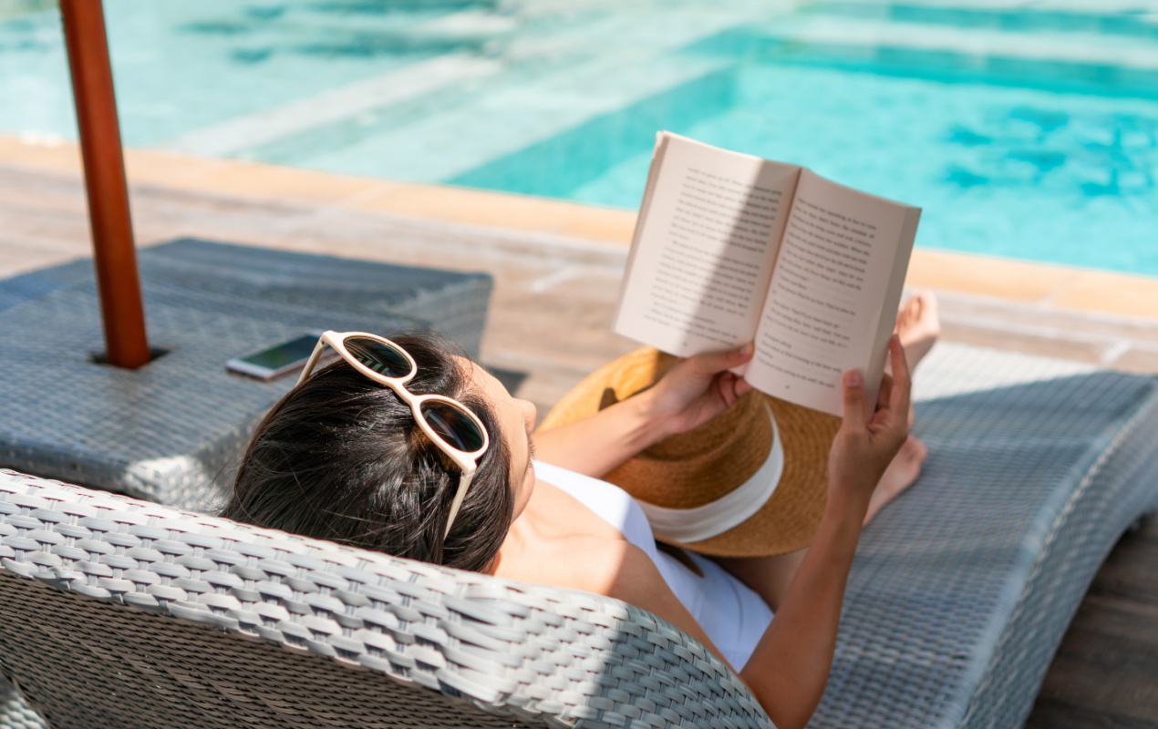 Woman reading next to a pool at a los cabos luxury villa