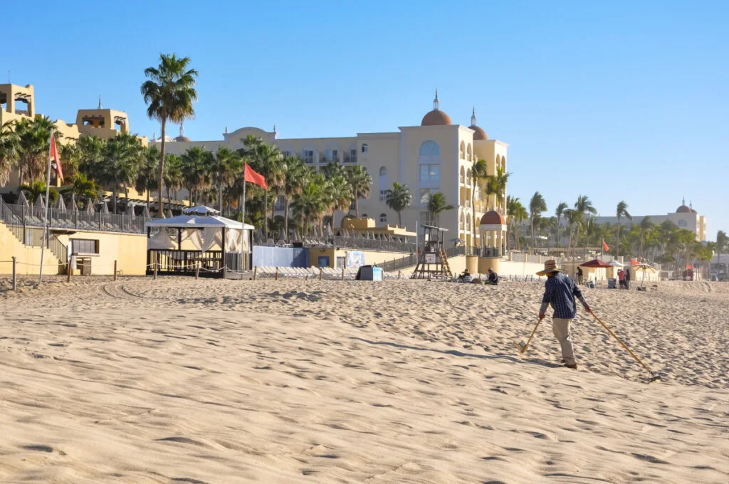 A beach sweeper in the morning at Playa Medano Los Cabos. cleaning the beach