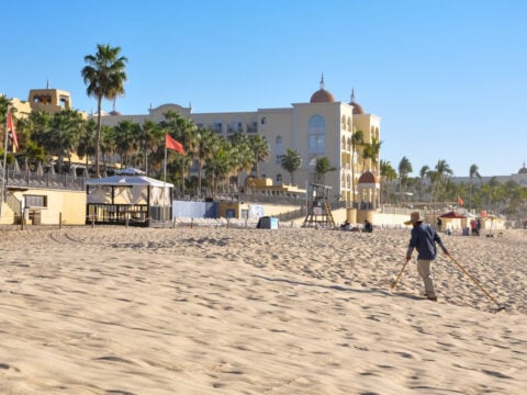 A beach sweeper in the morning at Playa Medano Los Cabos. cleaning the beach