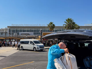 Man loading bag into private transportation in front of Los Cabos International Airport